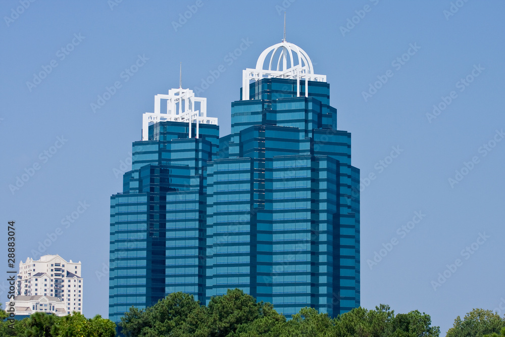 Two Modern Blue Office Towers with White Crowns
