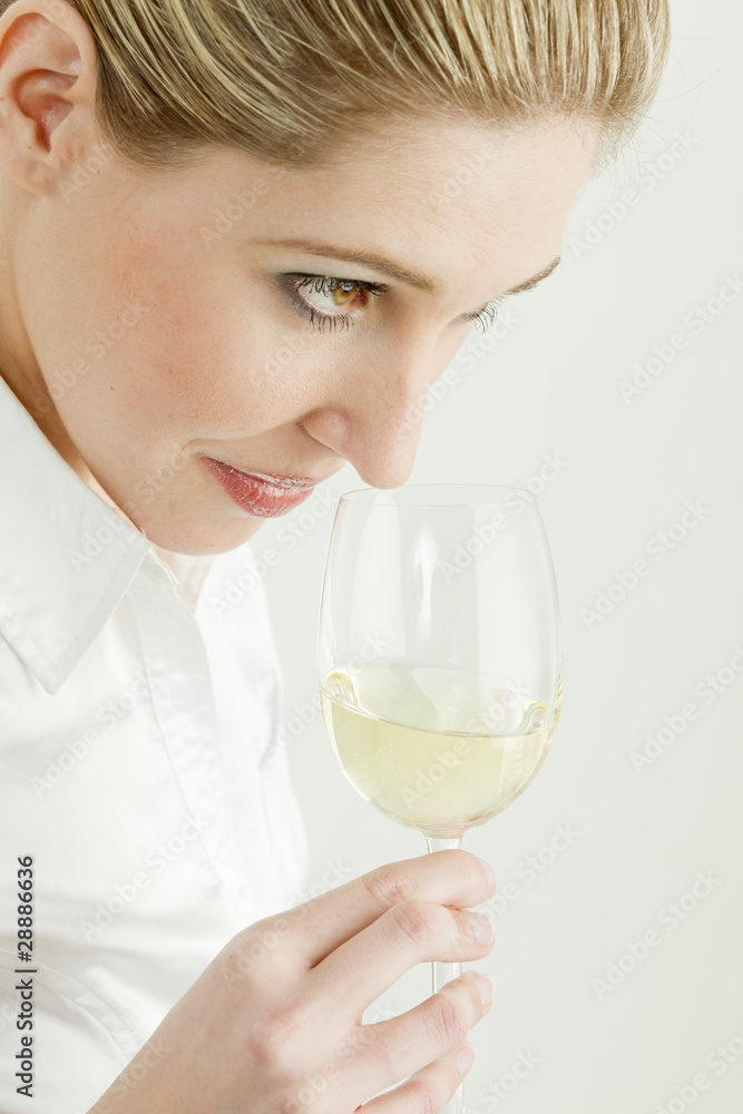 portrait of young woman tasting white wine portrait of young woman tasting white wine