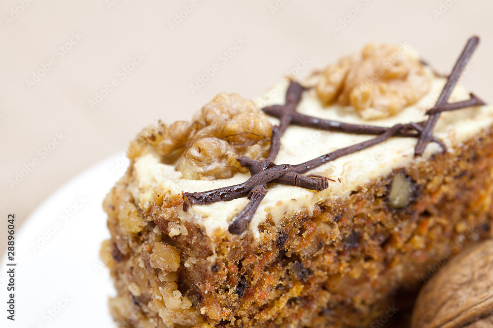 Piece of cake with nuts lying on the plate Piece of cake with nuts lying on the plate