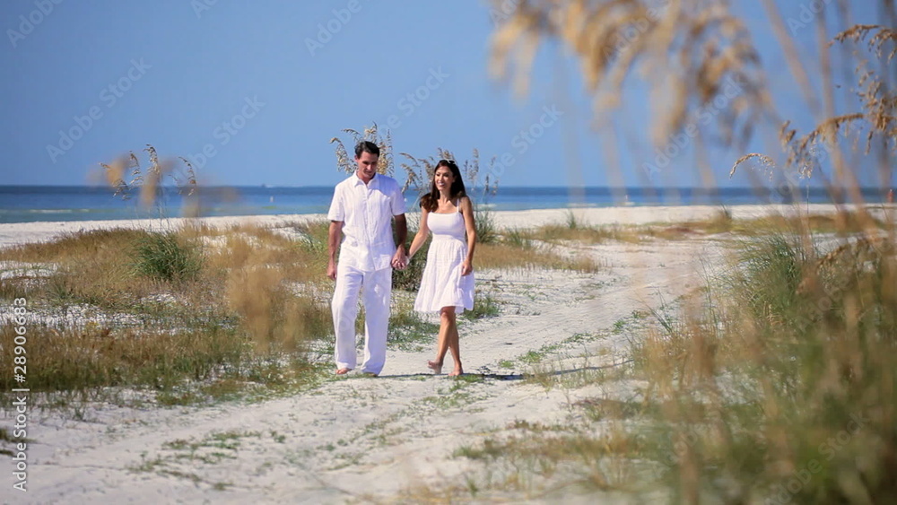 Happy Young Couple Walking the Beach Happy Young Couple Walking the Beach