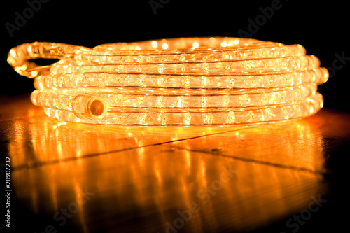 festive abstract of rope lights on a reflective floor photo