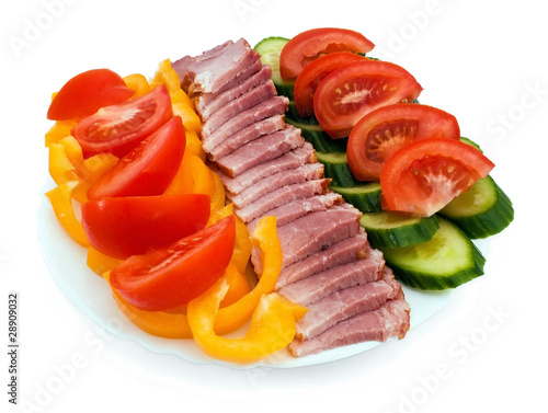 Plate of sliced tomato, cucumber, ham and yellow pepper