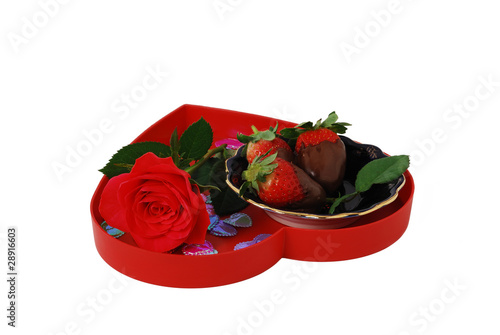 Strawberries in chocolate on red heart shaped tray