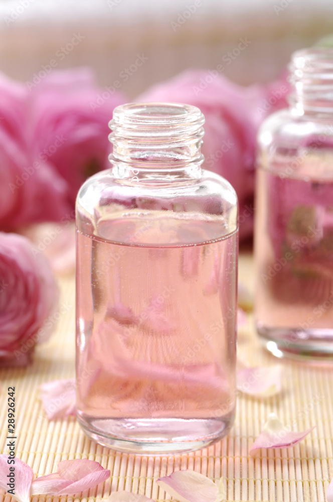 Aromatic massage oil and pink gardenia flowers Aromatic massage oil and pink gardenia flowers
