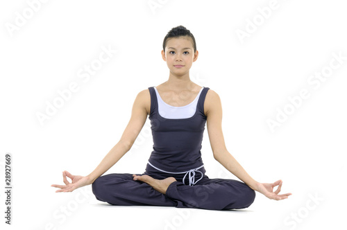 Young woman doing yoga moves or meditating