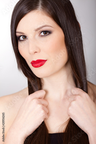 Sensual  woman with beautiful long brown hairs and red lips