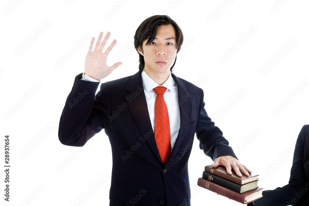Serious Asian Business Man Swearing on Stack of Bibles, Isolated Serious Asian Business Man Swearing on Stack of Bibles, Isolated