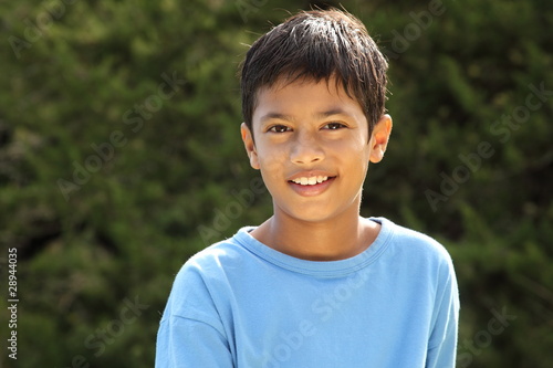 Happy smile from young boy in countryside sunshine