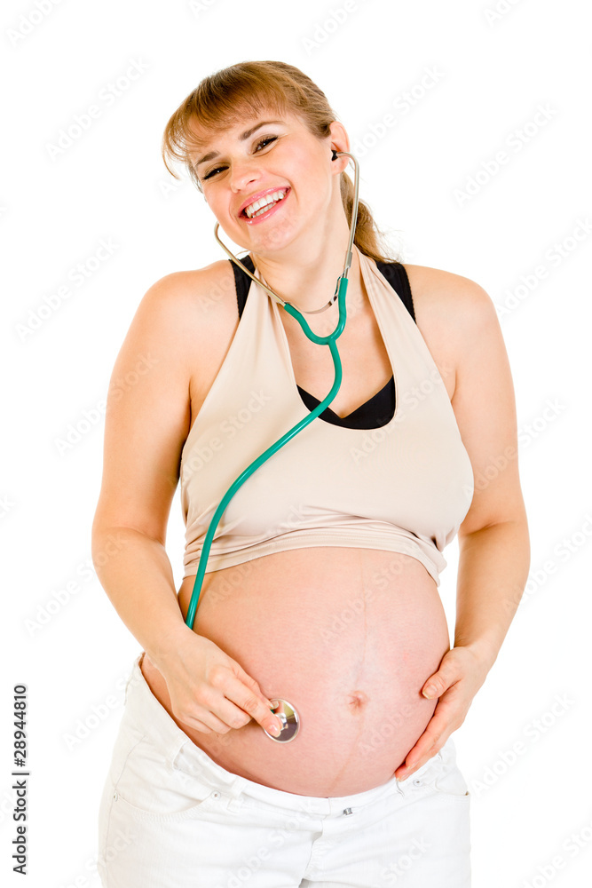 Happy pregnant woman holding stethascope on her belly Happy pregnant woman holding stethascope on her belly