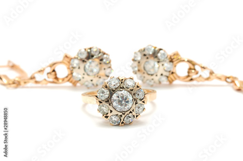 Gold Ring And Earrings with Diamonds on White Background