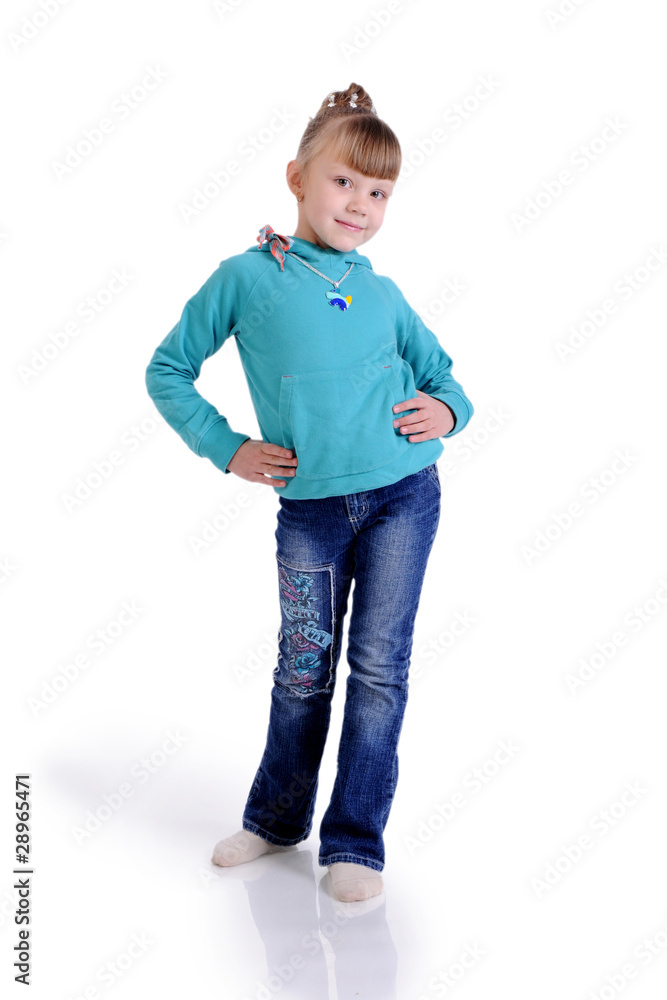 Charming little girl standing in a model pose. Isolated on the w Charming little girl standing in a model pose. Isolated on the w