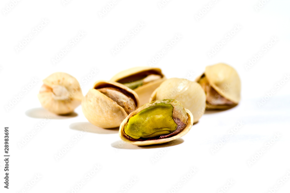 closeup image of pistachios on white background closeup image of pistachios on white background