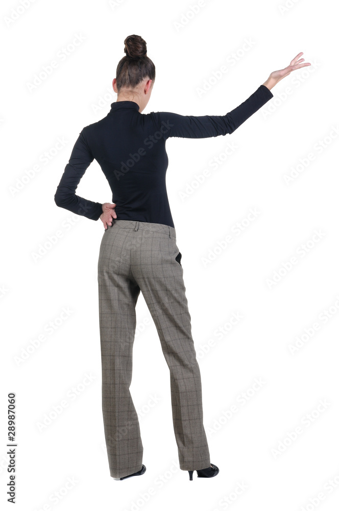 Beautiful young woman pointing at wall. Rear view. Beautiful young woman pointing at wall. Rear view.