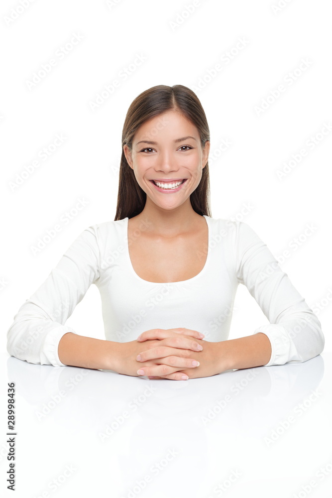 Woman in white sitting by table Woman in white sitting by table