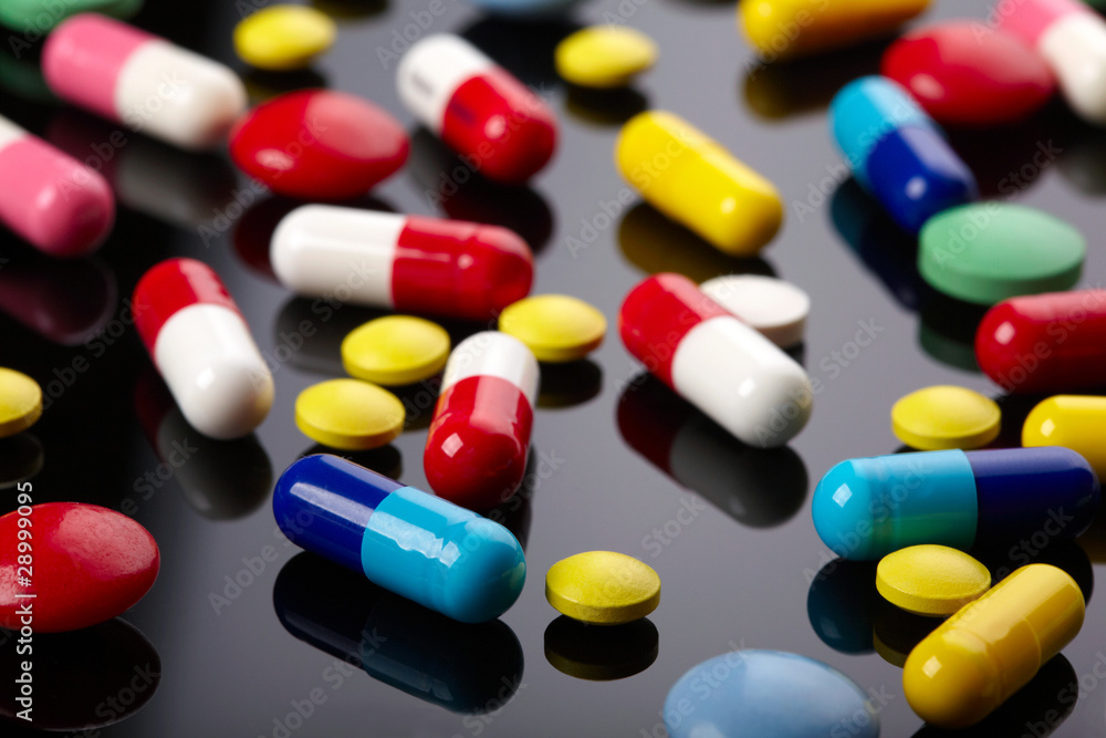Colorful pills over dark background Colorful pills over dark background