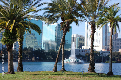 Orlando, Florida. Lake Eola and palm trees in foreground.