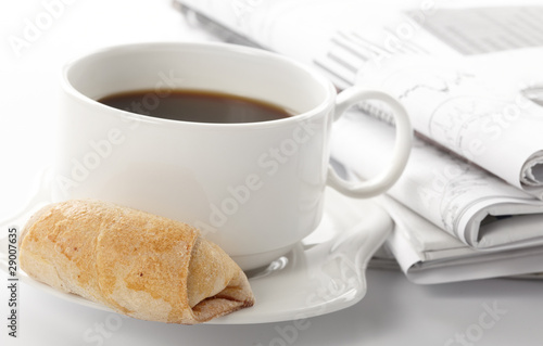 Cup of fragrant coffee on a morning paper business news