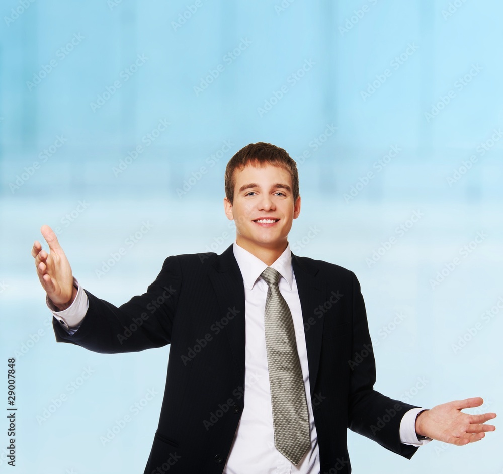 Happy young businessman with open hands Happy young businessman with open hands