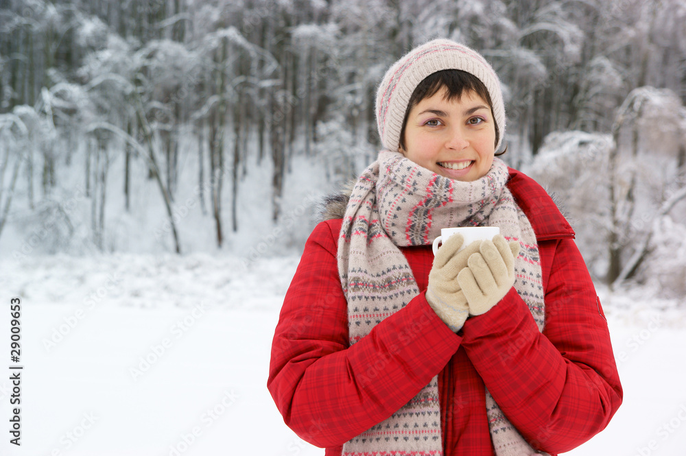 Young woman with cup in winter park Young woman with cup in winter park