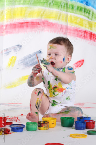 little girl bedaubed with bright colors photo