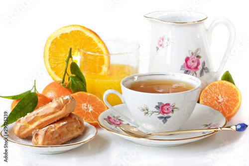 Beautiful breakfast. Green tea, eclairs, juice and fruit.