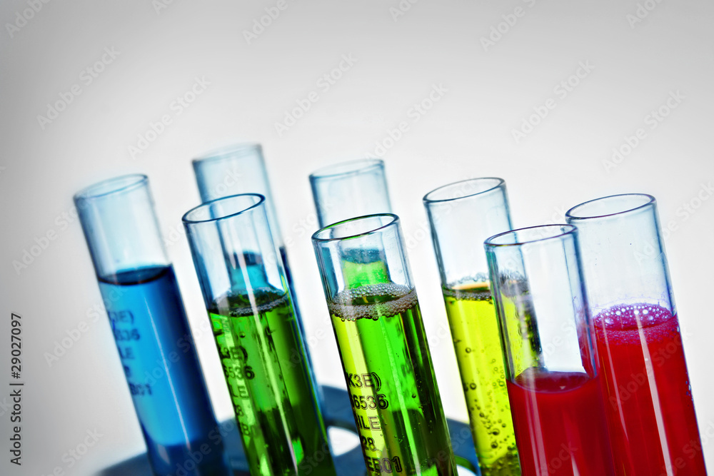 Multicoloured test tubes in the stand on grey background Multicoloured test tubes in the stand on grey background