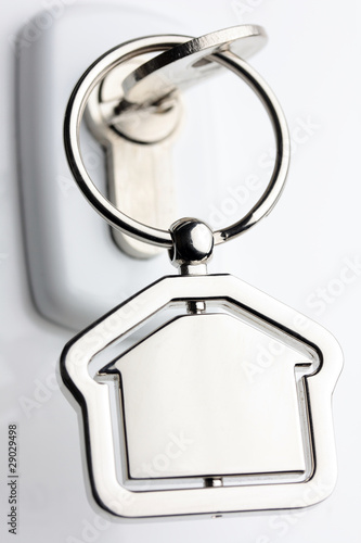 Macro of a lock and key with metal house figure