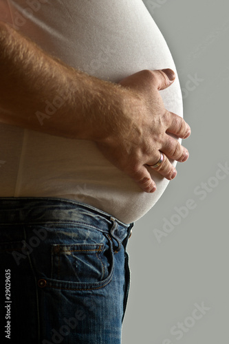 Overweight man with hand on belly