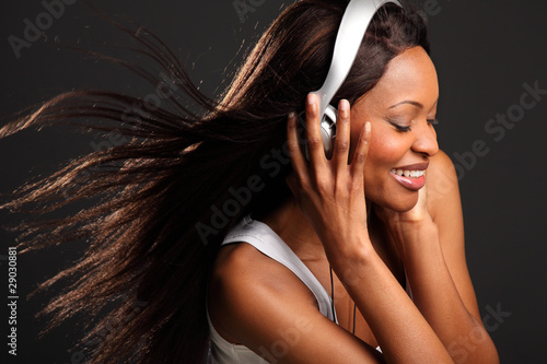 Beautiful happy black woman listening to music