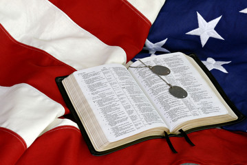 Bible with Dog Tags on American Flag