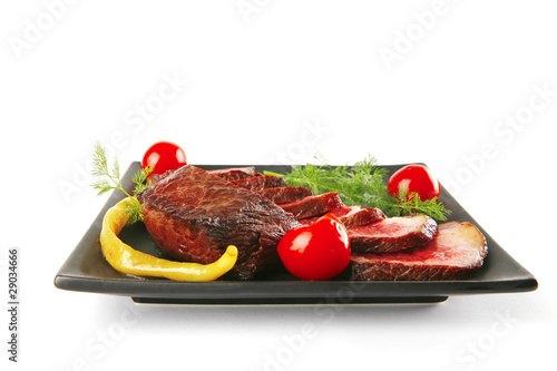 sliced meat on dark plate