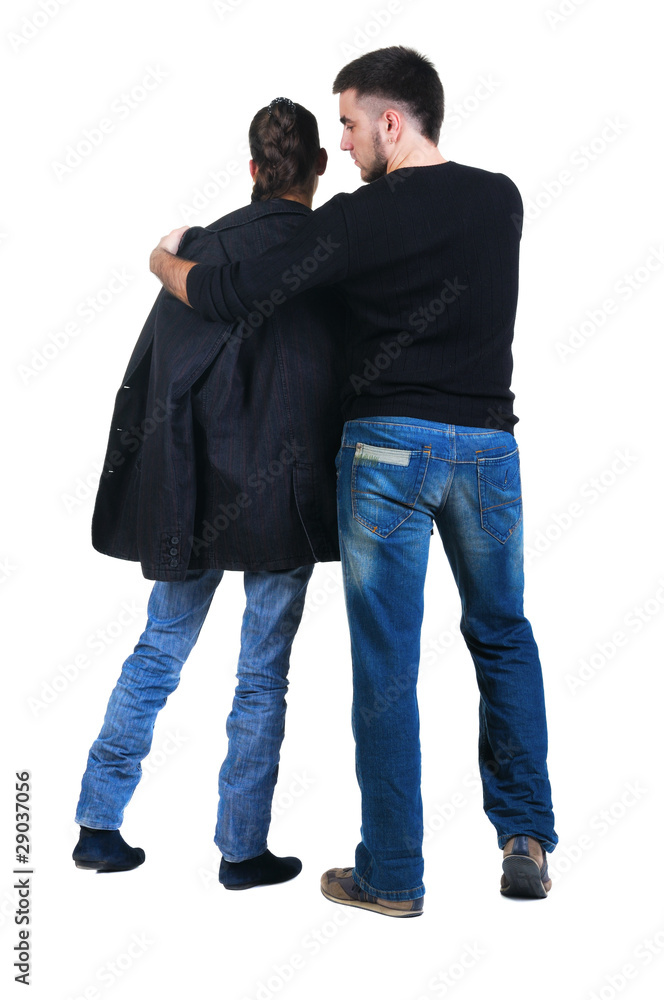 Young couple looks where that. Rear view. Young couple looks where that. Rear view.