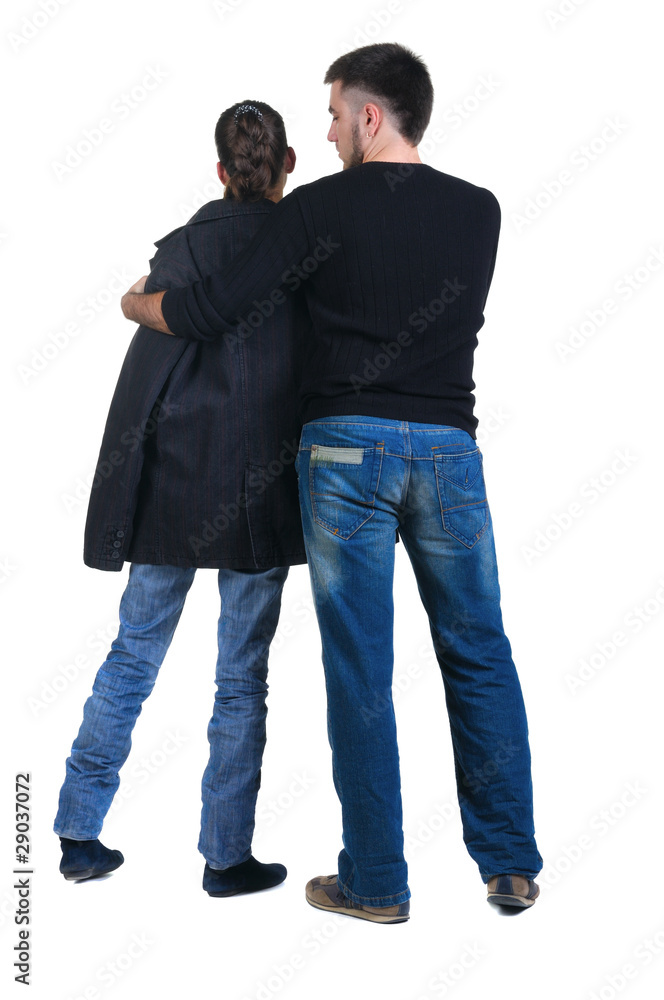 Young couple looks where that. Rear view. Young couple looks where that. Rear view.