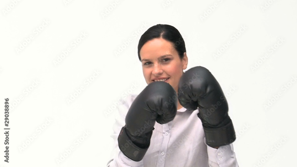 Smiling businesswoman boxing towards the camera Smiling businesswoman boxing towards the camera