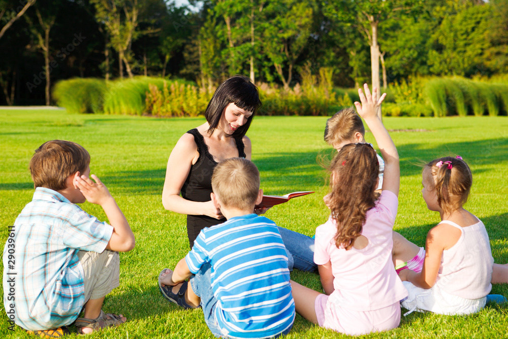 Fototapeta premium Teacher reading to kids