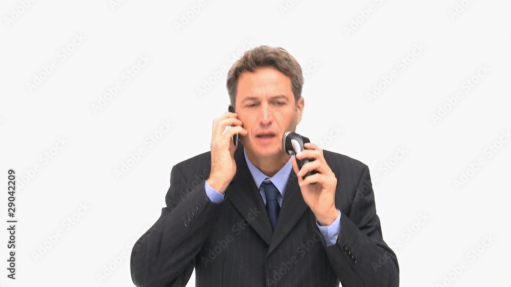 Stressed man shaving himself while is phoning Stressed man shaving himself while is phoning