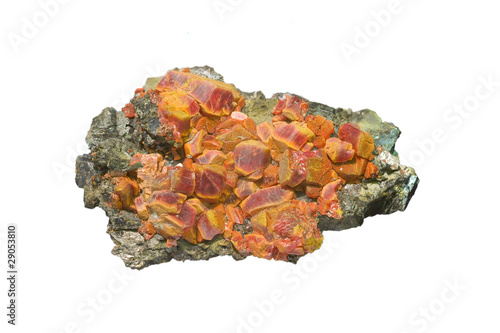 Red realgar crystals with orpiment on white, arsenic mineral. photo