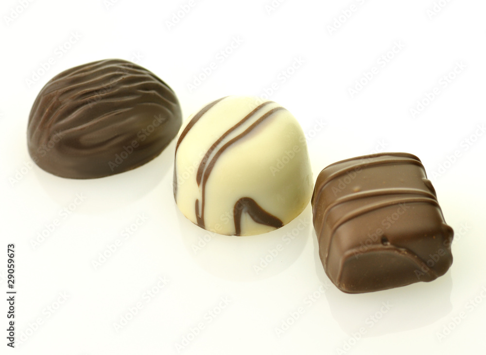 white and dark chocolate candies on white background white and dark chocolate candies on white background