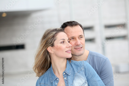 Portrait of happy couple standing outdoors © goodluz