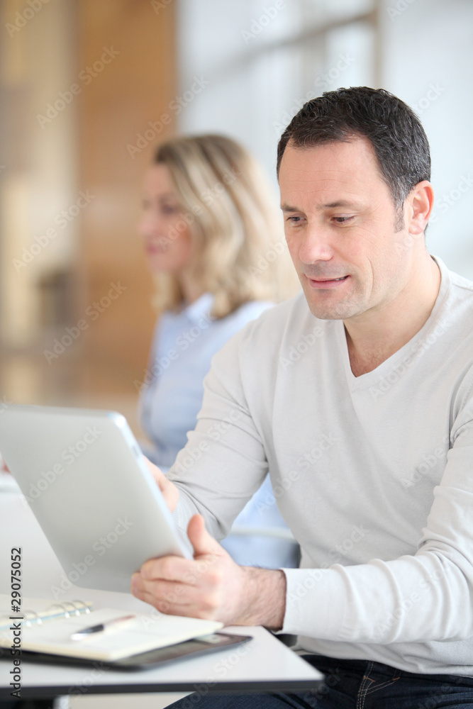 Office worker in the office using electronic tab Office worker in the office using electronic tab