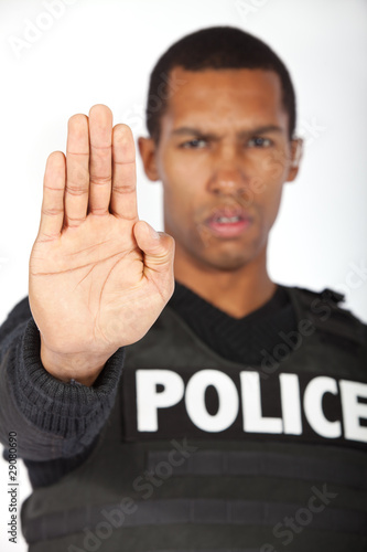 Police officer putting his hand up.  Shallow depth of field.