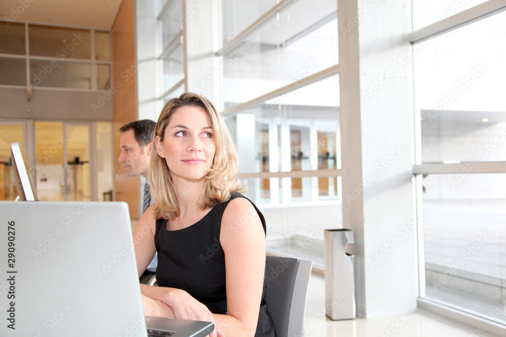 Businesswoman sitting in the office in front of laptop Businesswoman sitting in the office in front of laptop