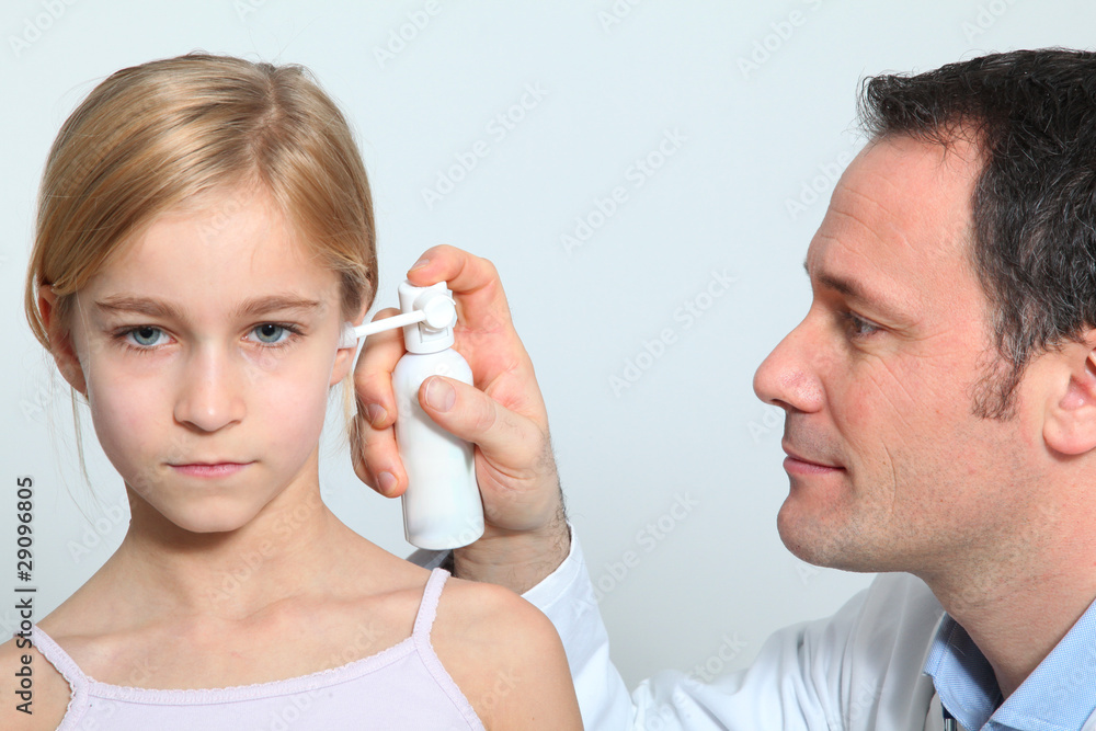 Doctor treating little girl ear infection