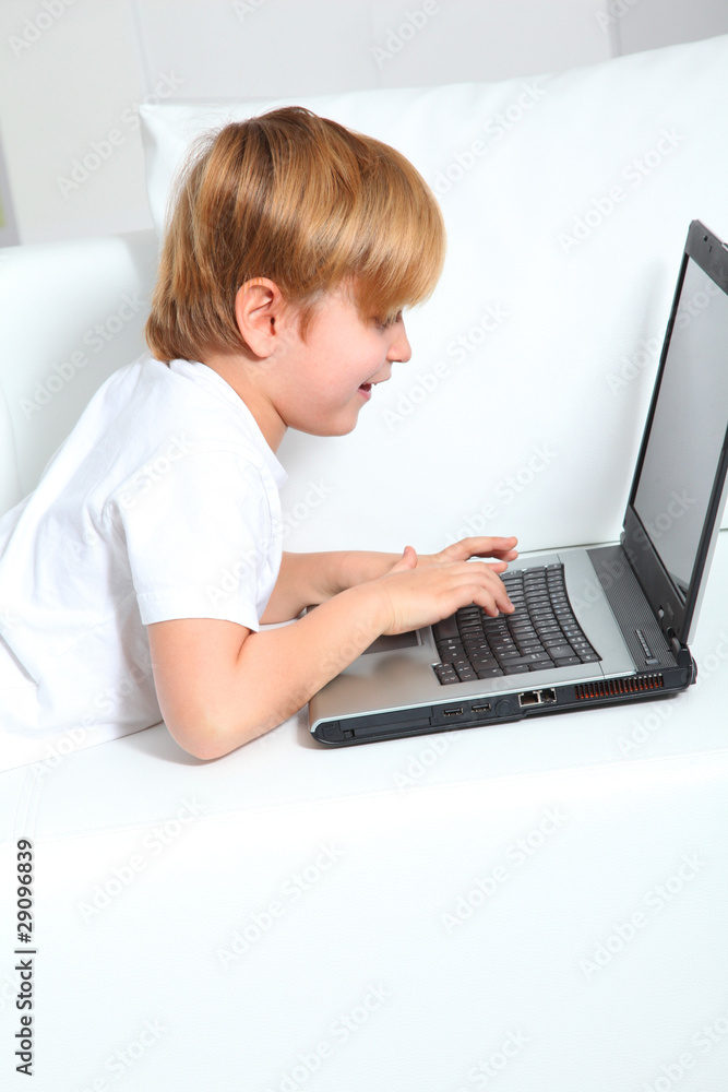 Little boy using laptop computer at home Little boy using laptop computer at home