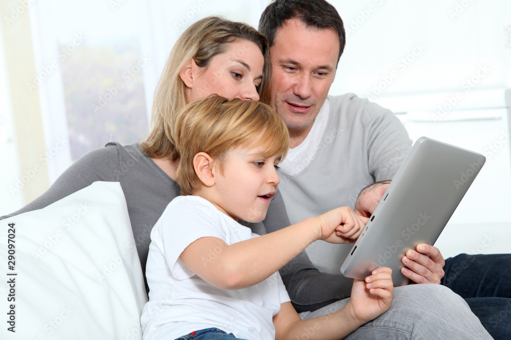 Parents and little boy using electronic tab Parents and little boy using electronic tab