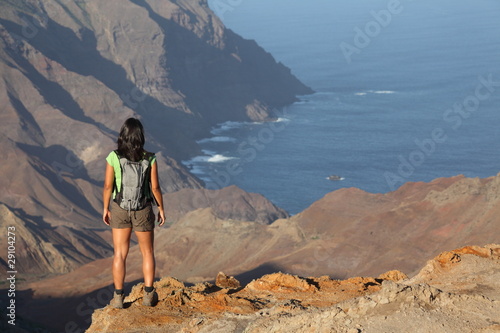 Woman hiking on top volcanic craters on St Helena