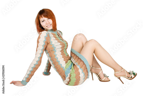 beauty redhead woman in fashion dress sitting on floor and smili