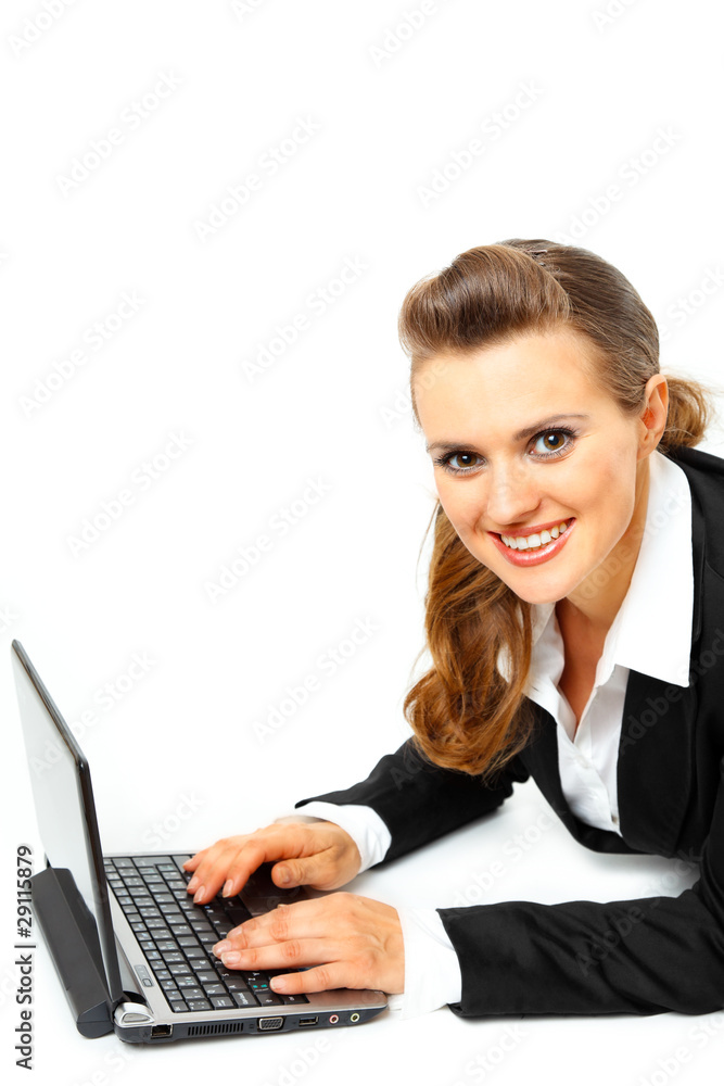 Laying on floor smiling modern business woman using laptop Laying on floor smiling modern business woman using laptop