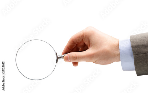 Magnifying glass in hand isolated on white background