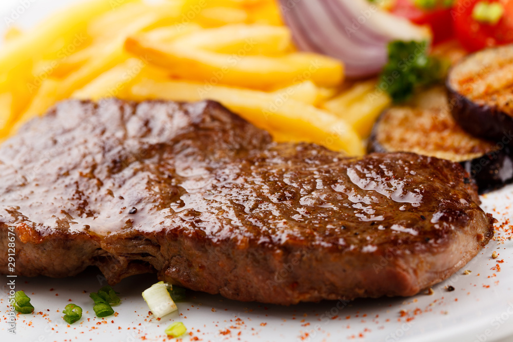 Steak with chips and vegetables Steak with chips and vegetables